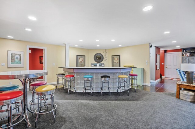 4126 Timberline Dr S, Fargo, ND 58104 - bar with recessed lighting, baseboards, dark tile patterned flooring, and dark colored carpet