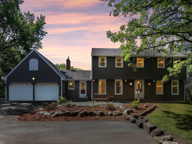 12576 Ridgewood Dr NW, Elk River, MN 55330 - colonial home featuring driveway, a garage, a yard, and a chimney