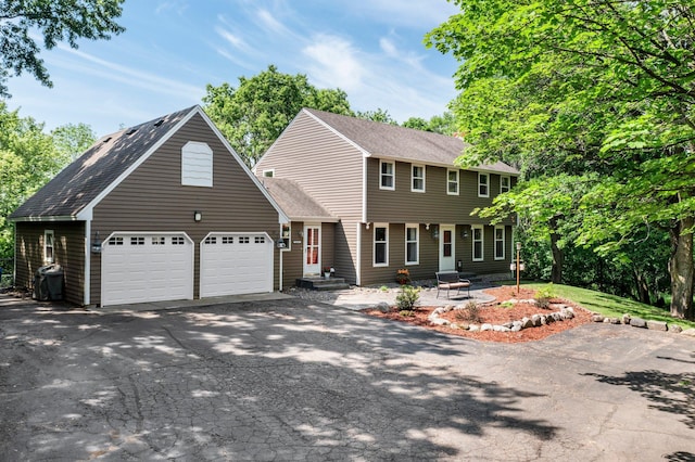 12576 Ridgewood Dr NW, Elk River, MN 55330 - colonial home with asphalt driveway, a shingled roof, and a garage