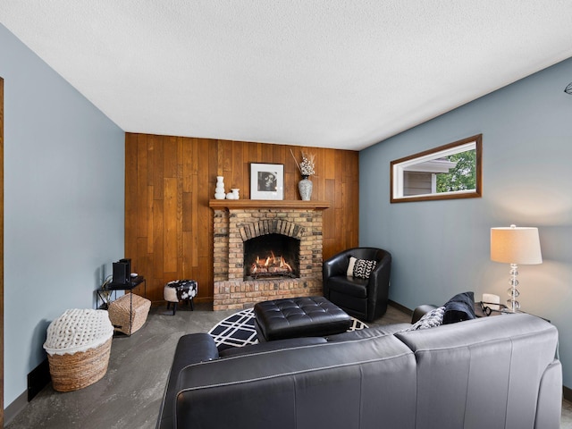 12576 Ridgewood Dr NW, Elk River, MN 55330 - living room with wooden walls, a fireplace, baseboards, a textured ceiling, and an accent wall