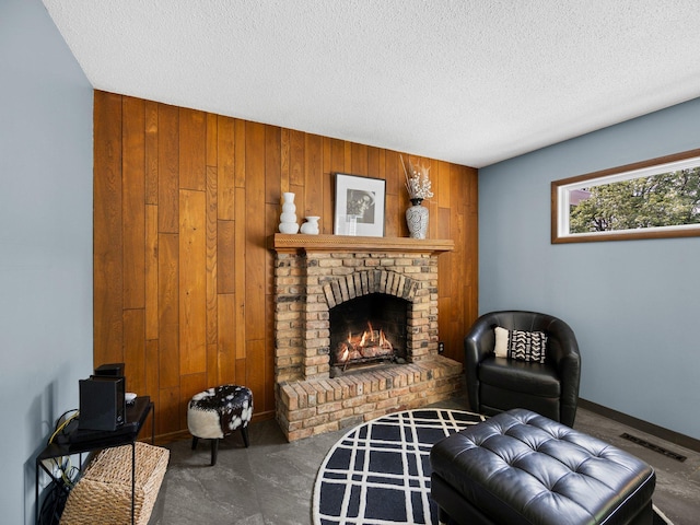 12576 Ridgewood Dr NW, Elk River, MN 55330 - living area with wooden walls, a fireplace, carpet flooring, and a textured ceiling