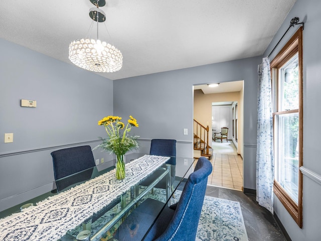 12576 Ridgewood Dr NW, Elk River, MN 55330 - dining area with stairs, a chandelier, a textured ceiling, and baseboards