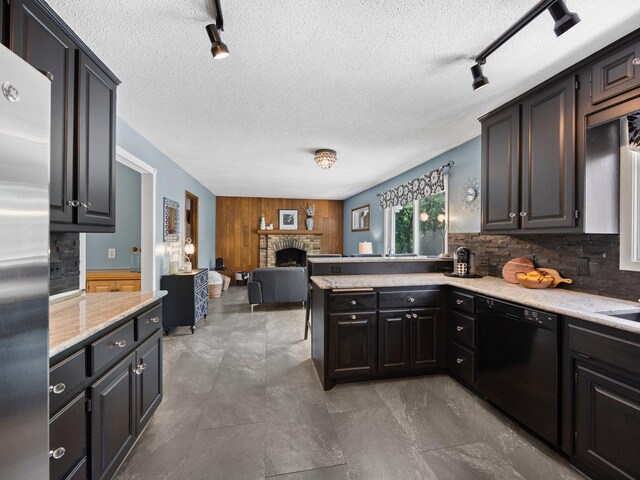 12576 Ridgewood Dr NW, Elk River, MN 55330 - kitchen featuring dishwasher, freestanding refrigerator, track lighting, a stone fireplace, and light countertops