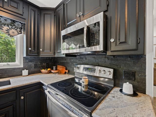 12576 Ridgewood Dr NW, Elk River, MN 55330 - kitchen with appliances with stainless steel finishes and backsplash