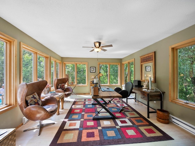 12576 Ridgewood Dr NW, Elk River, MN 55330 - living room with baseboard heating, healthy amount of natural light, ceiling fan, a textured ceiling, and light wood-style flooring