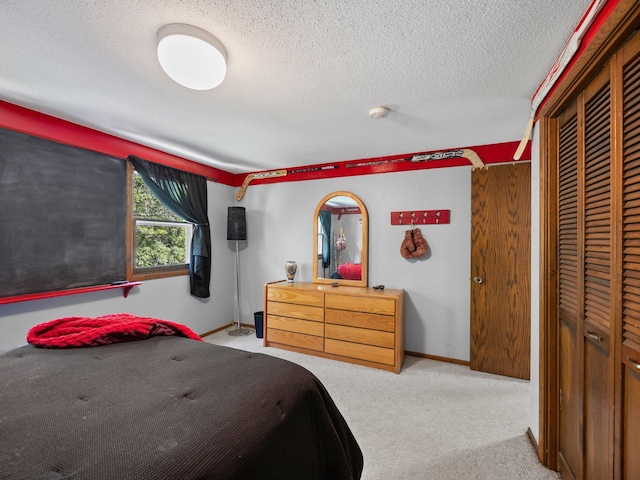 12576 Ridgewood Dr NW, Elk River, MN 55330 - bedroom featuring carpet floors, a textured ceiling, a closet, and baseboards