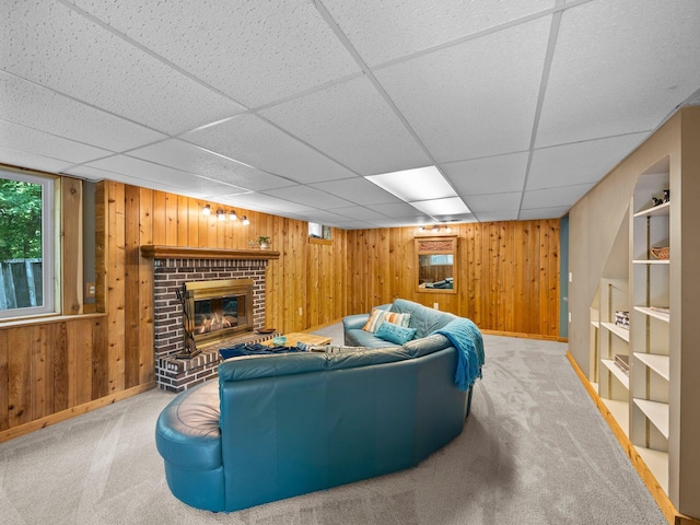 12576 Ridgewood Dr NW, Elk River, MN 55330 - living area with wooden walls, baseboards, carpet flooring, a drop ceiling, and a brick fireplace