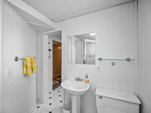 12576 Ridgewood Dr NW, Elk River, MN 55330 - bathroom with toilet, a stall shower, tile patterned floors, and wooden walls