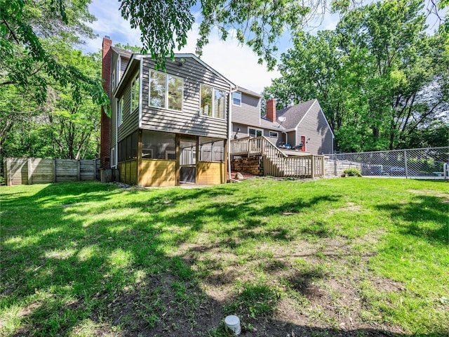 12576 Ridgewood Dr NW, Elk River, MN 55330 - back of property with a chimney, a deck, and stairway