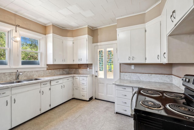 kitchen featuring stainless steel electric range oven, a sink, ornamental molding, light countertops, and white cabinets