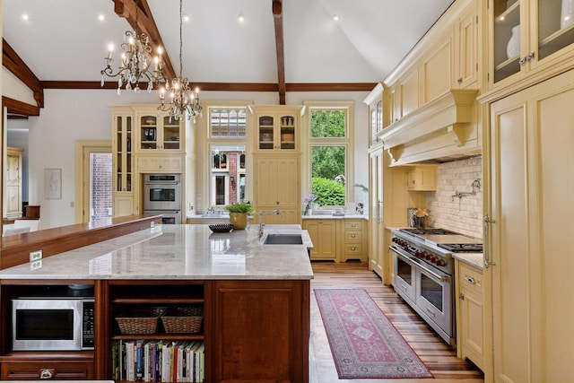 1721 Mount Curve Ave, Minneapolis, MN 55403 - kitchen with cream cabinetry, stainless steel appliances, a sink, and light wood finished floors