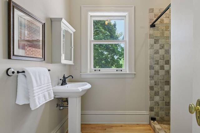 1721 Mount Curve Ave, Minneapolis, MN 55403 - full bathroom with healthy amount of natural light, tiled shower, and wood finished floors