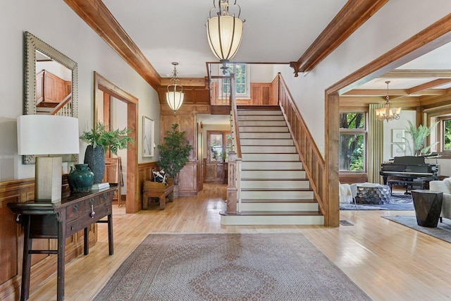 1721 Mount Curve Ave, Minneapolis, MN 55403 - foyer with wood finished floors, stairs, a chandelier, and crown molding
