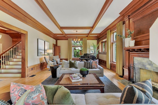 1721 Mount Curve Ave, Minneapolis, MN 55403 - living room featuring a chandelier, a premium fireplace, light wood finished floors, coffered ceiling, and stairway