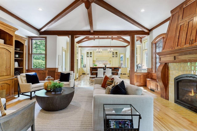 1721 Mount Curve Ave, Minneapolis, MN 55403 - living area featuring a fireplace with flush hearth, light wood-style floors, wainscoting, and a chandelier