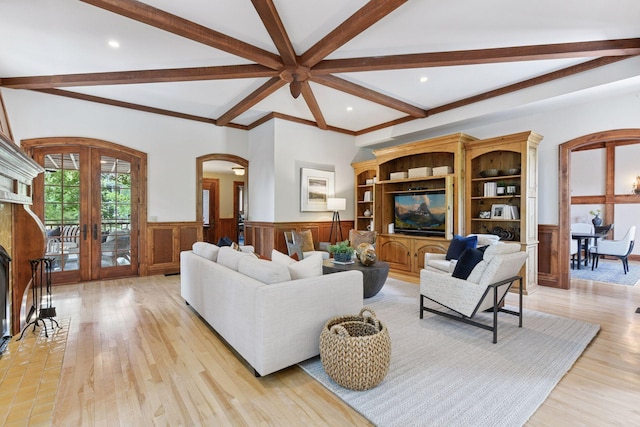 1721 Mount Curve Ave, Minneapolis, MN 55403 - living room featuring arched walkways, beam ceiling, wainscoting, french doors, and light wood-style flooring