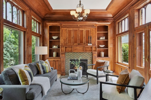 1721 Mount Curve Ave, Minneapolis, MN 55403 - living room with ornamental molding, built in shelves, a chandelier, coffered ceiling, and a brick fireplace