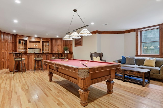 1721 Mount Curve Ave, Minneapolis, MN 55403 - recreation room with light wood finished floors, ornamental molding, billiards, recessed lighting, and bar with sink