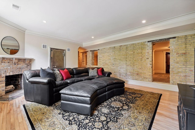 1721 Mount Curve Ave, Minneapolis, MN 55403 - living area with a fireplace, light wood-style flooring, brick wall, ornamental molding, and recessed lighting