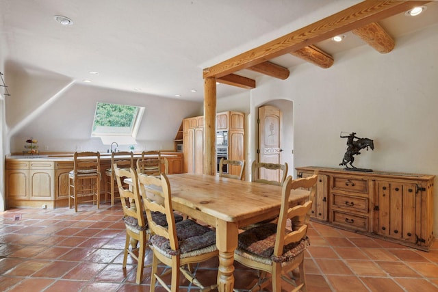 1721 Mount Curve Ave, Minneapolis, MN 55403 - dining room featuring a skylight, light tile patterned floors, recessed lighting, and arched walkways