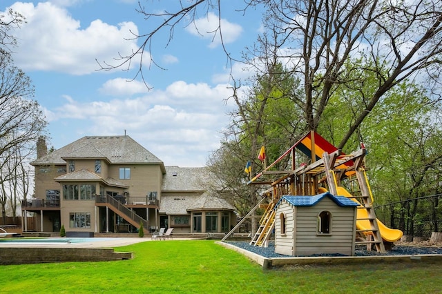view of playground with stairs and a deck