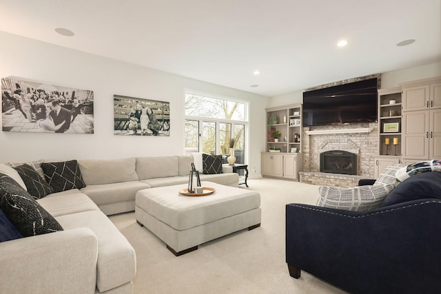 carpeted living room with a brick fireplace and recessed lighting