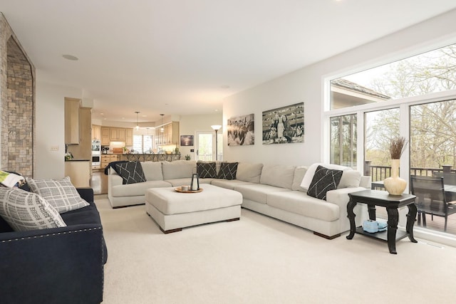 living area featuring light colored carpet
