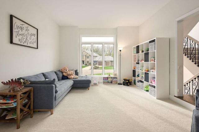 living room featuring carpet flooring and stairway