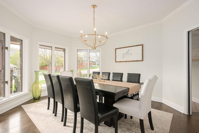 dining room with a chandelier, healthy amount of natural light, ornamental molding, and dark wood-style flooring