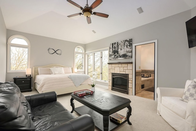 bedroom featuring lofted ceiling, carpet floors, a fireplace, and a ceiling fan