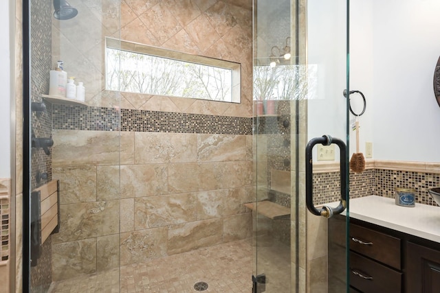 full bathroom with a stall shower and vanity