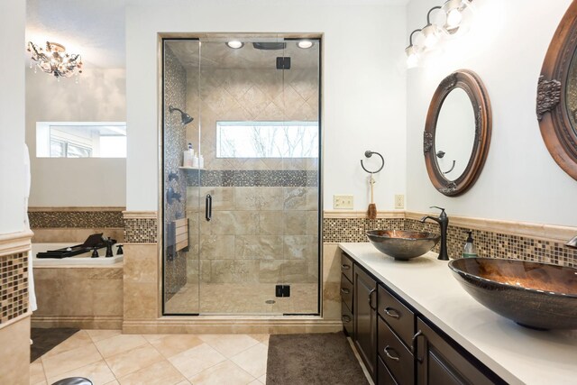 bathroom with a shower stall, tile patterned floors, a garden tub, and double vanity