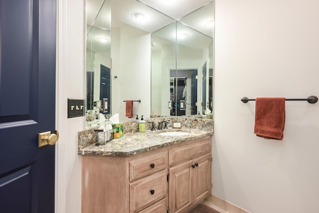 bathroom featuring vanity and baseboards