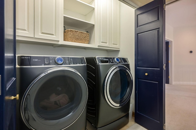 clothes washing area featuring washer and dryer and carpet