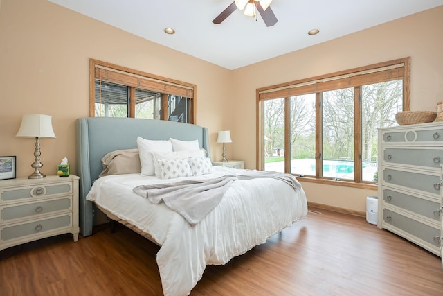 bedroom with wood finished floors, baseboards, ceiling fan, and recessed lighting
