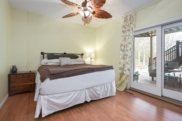 bedroom with access to outside, wood finished floors, a ceiling fan, and baseboards