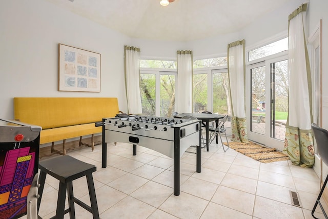 rec room featuring plenty of natural light and light tile patterned flooring
