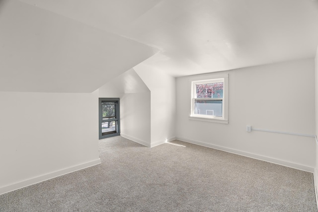 305 Pierson Ave, New Richmond, WI 54017 - additional living space with carpet, plenty of natural light, baseboards, and vaulted ceiling