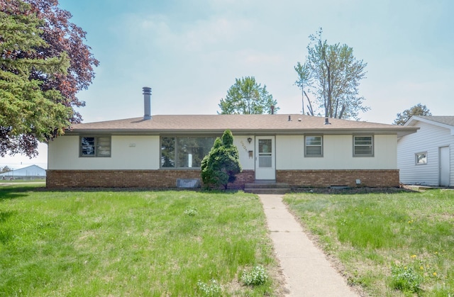 ranch-style house with brick siding and a front lawn