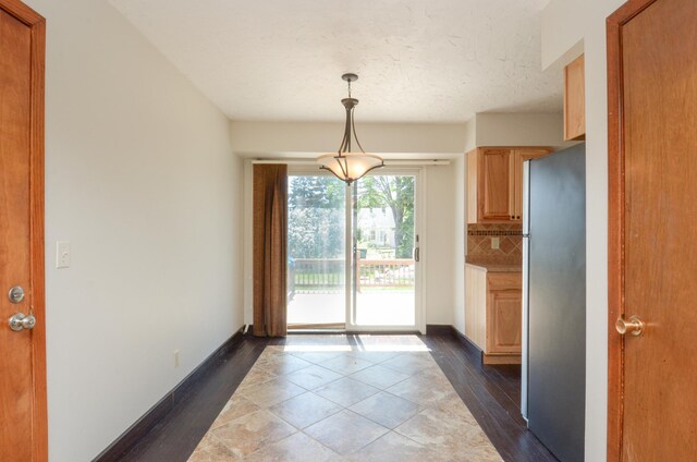doorway to outside featuring dark wood-type flooring and baseboards