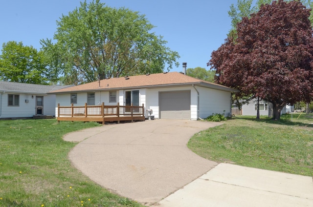 single story home with an attached garage, a front lawn, concrete driveway, and a deck