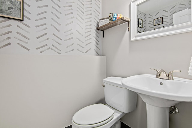 half bath with toilet and a sink