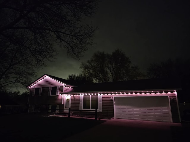 split level home with an attached garage and driveway
