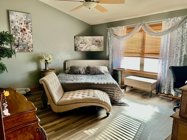 bedroom featuring a ceiling fan, visible vents, wood finished floors, and lofted ceiling