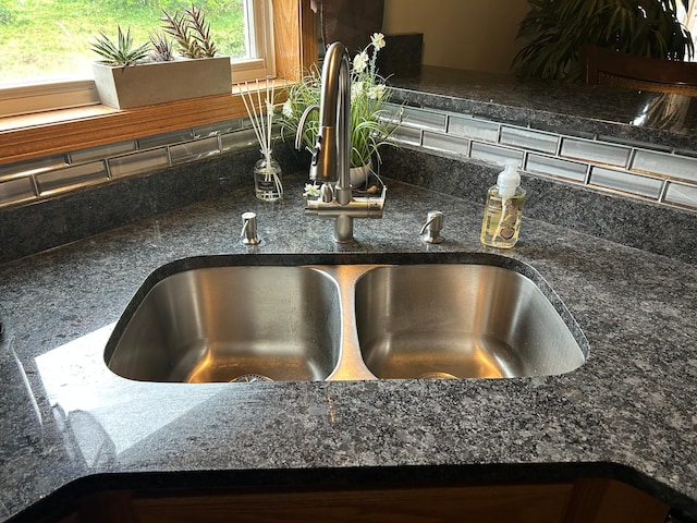 7263 Falmouth Curv, Shakopee, MN 55379 - kitchen view of a sink, tasteful backsplash, and dark stone countertops