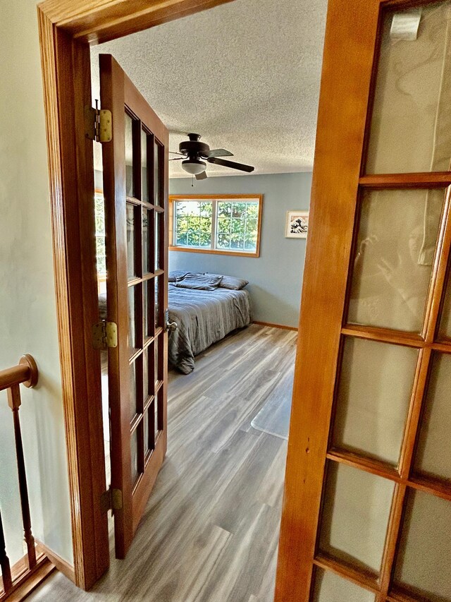 7263 Falmouth Curv, Shakopee, MN 55379 - bedroom with wood finished floors, a textured ceiling, and a ceiling fan