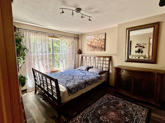 7263 Falmouth Curv, Shakopee, MN 55379 - bedroom with a textured ceiling, wood finished floors, and rail lighting