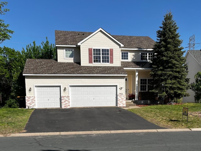 7263 Falmouth Curv, Shakopee, MN 55379 - traditional-style home featuring asphalt driveway, brick siding, a front lawn, and roof with shingles