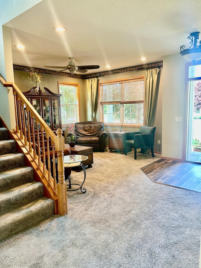 7263 Falmouth Curv, Shakopee, MN 55379 - living area with carpet floors, ceiling fan, healthy amount of natural light, stairs, and a textured ceiling