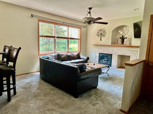 7263 Falmouth Curv, Shakopee, MN 55379 - living room with ceiling fan, carpet flooring, a textured ceiling, a fireplace, and baseboards